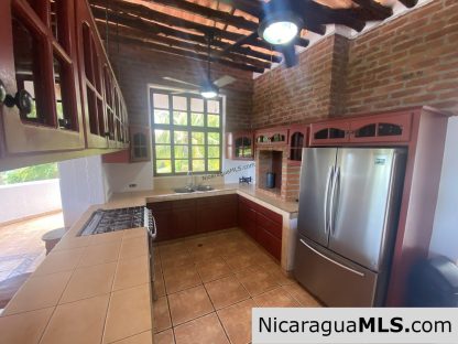 Landmark entertainer home in a quiet, gated development mere minutes from town
