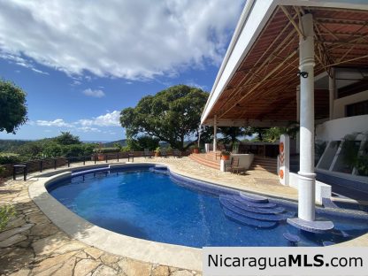 Landmark entertainer home in a quiet, gated development mere minutes from town